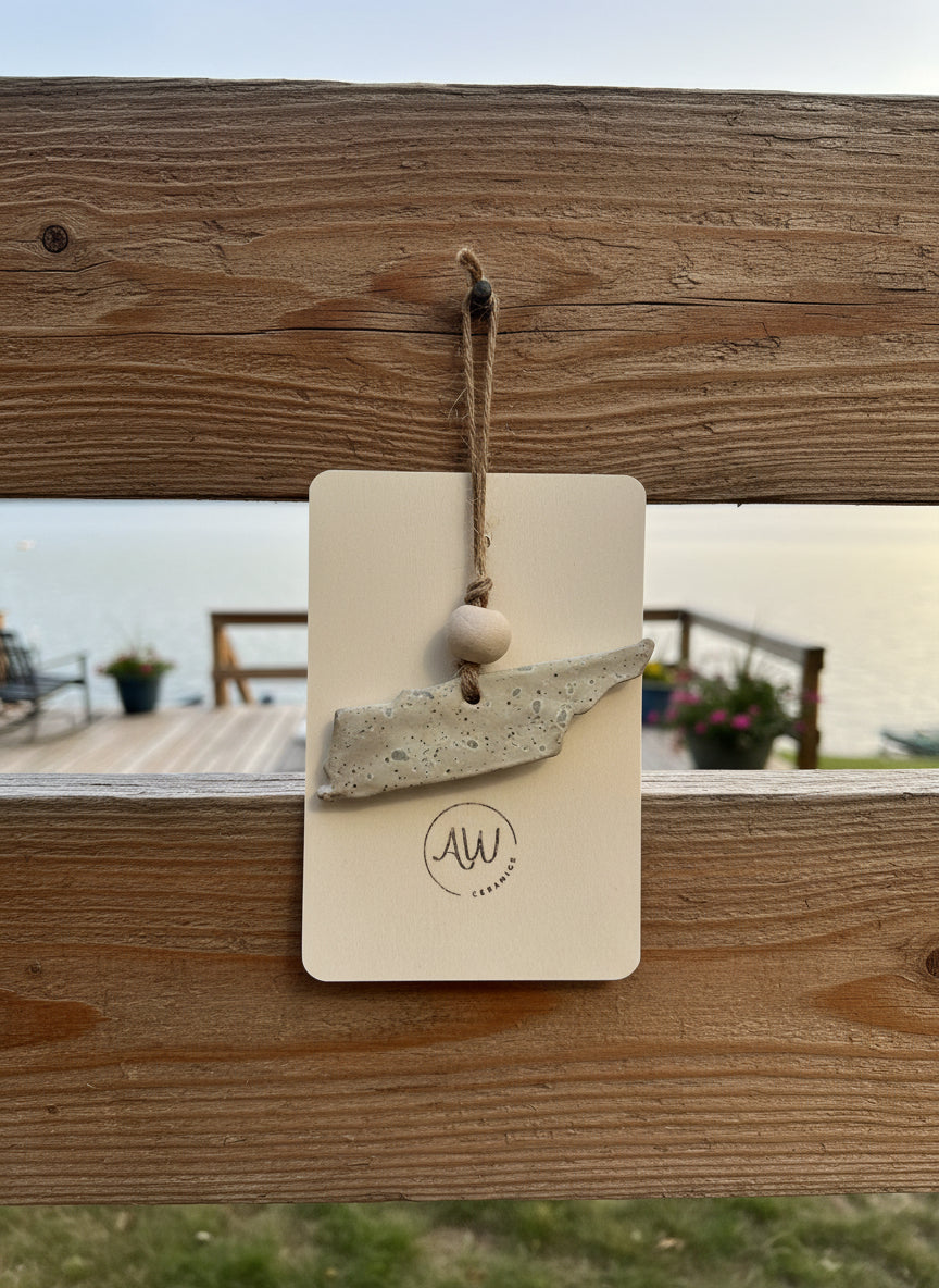 a white Tennessee ornament on a lakehouse patio